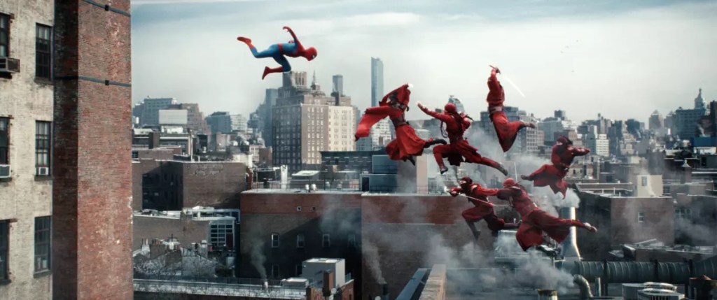 A dynamic scene featuring Spider-Man leaping through a city skyline, with multiple versions of him in red suits and capes soaring through the air above rooftops.