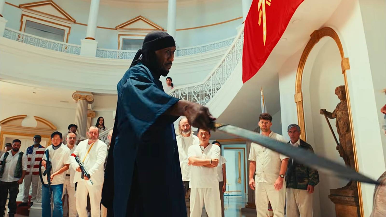 Mahershala Ali points a sword at a man in Your Mother Your Mother Your Mother